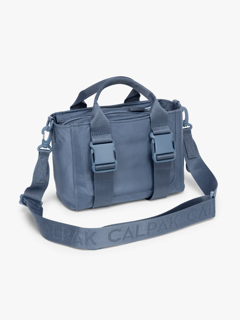 CALPAK Fit Gym Crossbody Bag in blue Indigo side view with white background
