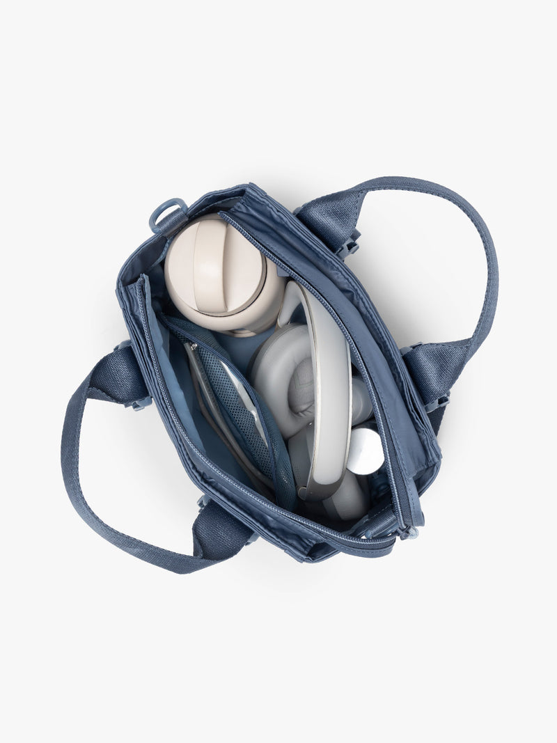 Inside of CALPAK Fit Gym Crossbody Bag in blue Indigo with white background