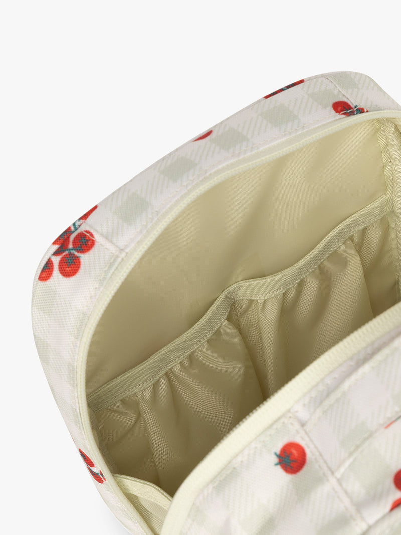 Pockets of CALPAK Everything Cube inlight and green gingham pattern with tomato print
