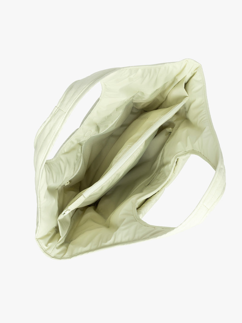 Opened interior view of the CALPAK Luka Everything Laptop Tote in light green Celadon with shoulder strap on a white background