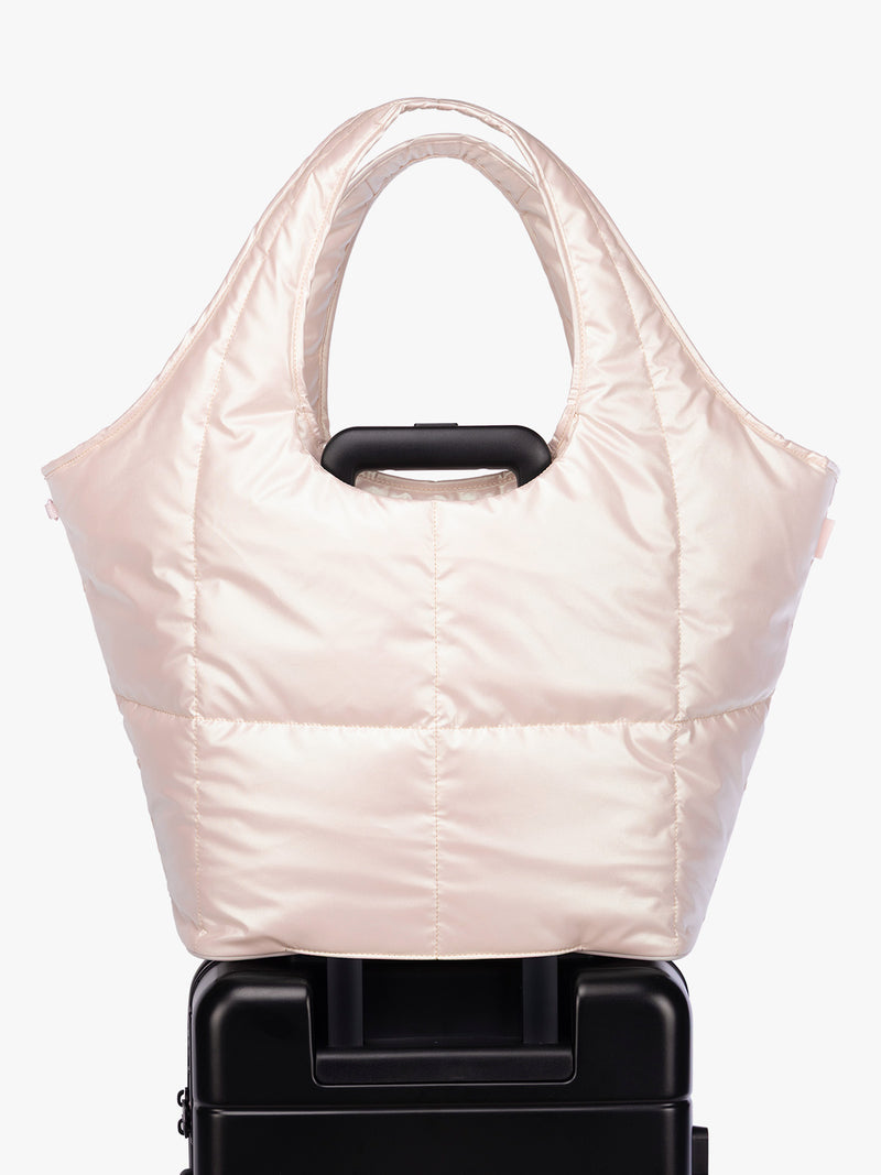 Luggage trolley sleeve of CALPAK Luka Everything Tote in light pink Pearlescent