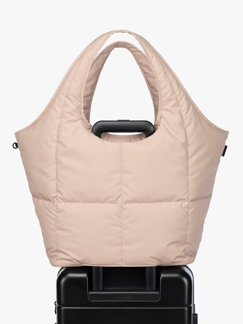 Luggage trolley sleeve of CALPAK Luka Everything Tote in light pink Rose Quartz