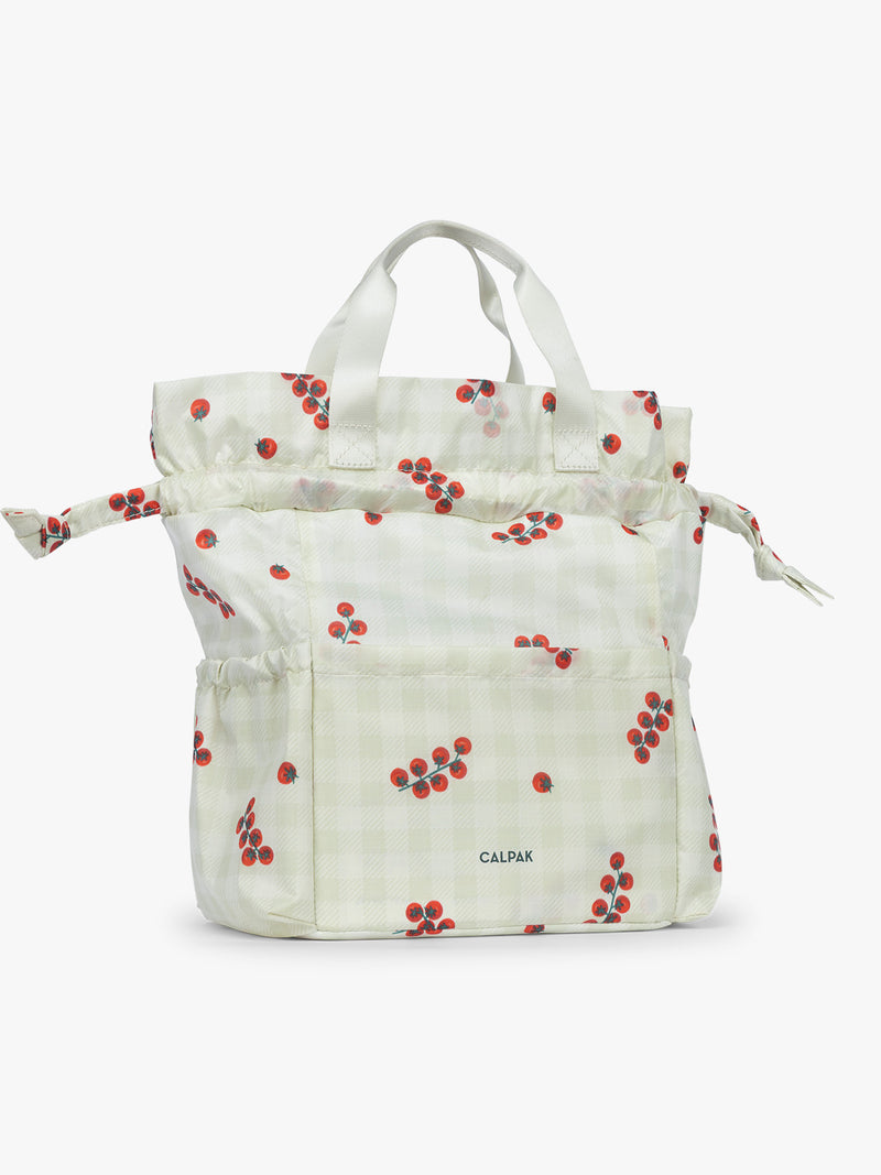 Extended view of CALPAK Insulated Lunch Bag in light green Celadon and white gingham print with red tomato pattern
