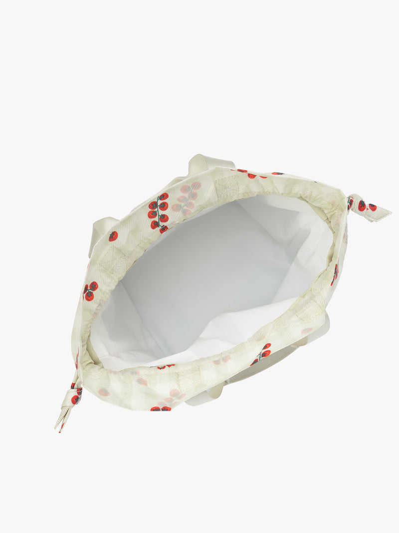 Inside view of CALPAK Insulated Lunch Bag in light green Celadon and white gingham print with red tomato pattern