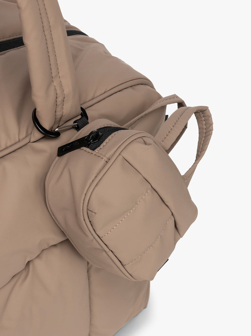 CALPAK Luka Duffel Key Pouch in brown Chocolate clipped onto the Luka Duffel in brown Chocolate