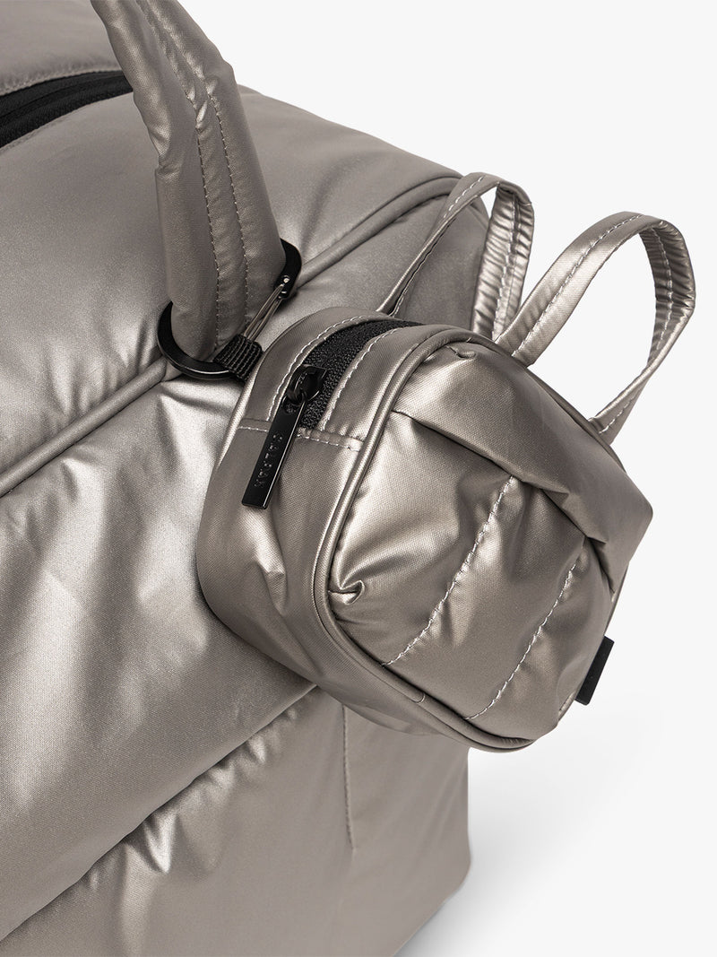 CALPAK Luka Duffel Zip Bag Charm in dark silver Gunmetal attached to bag
