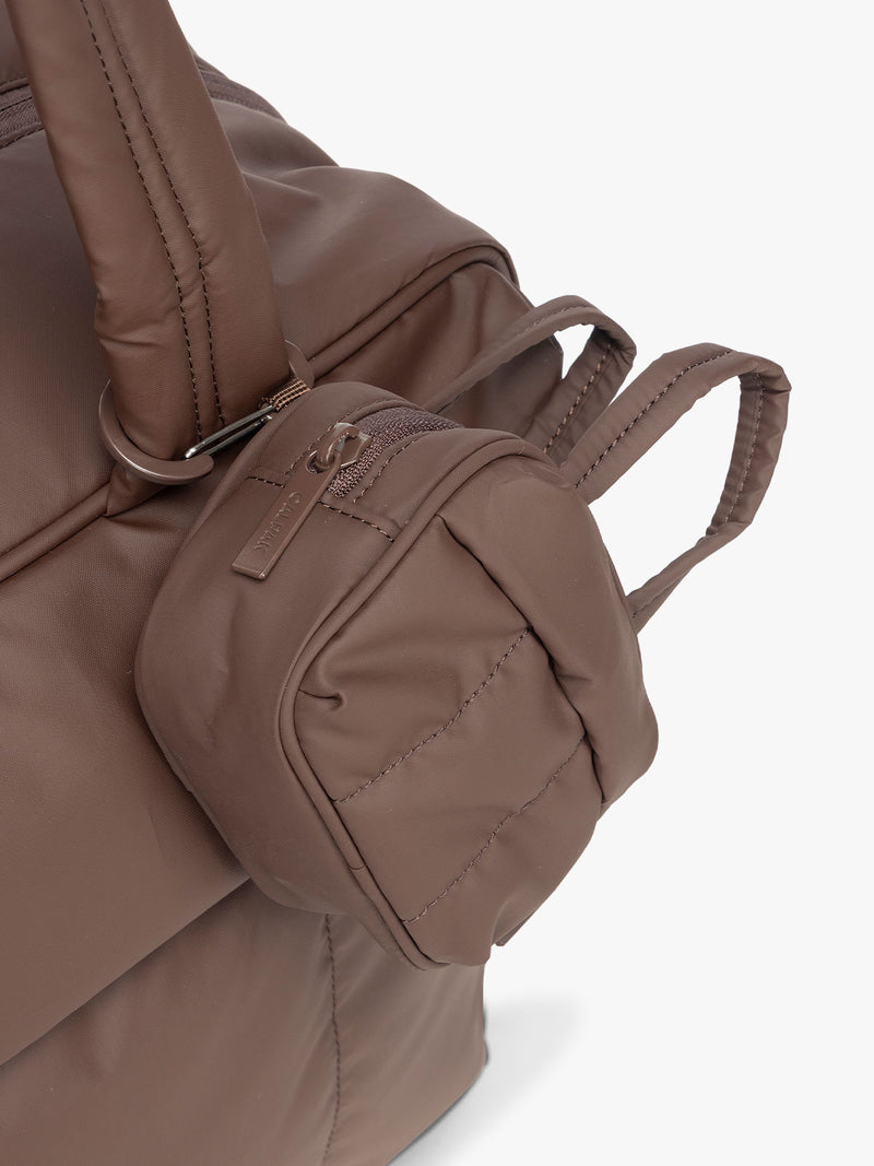 CALPAK Luka Duffel Key Pouch in brown monochrome Walnut attached to a Luka Duffel in brown Walnut