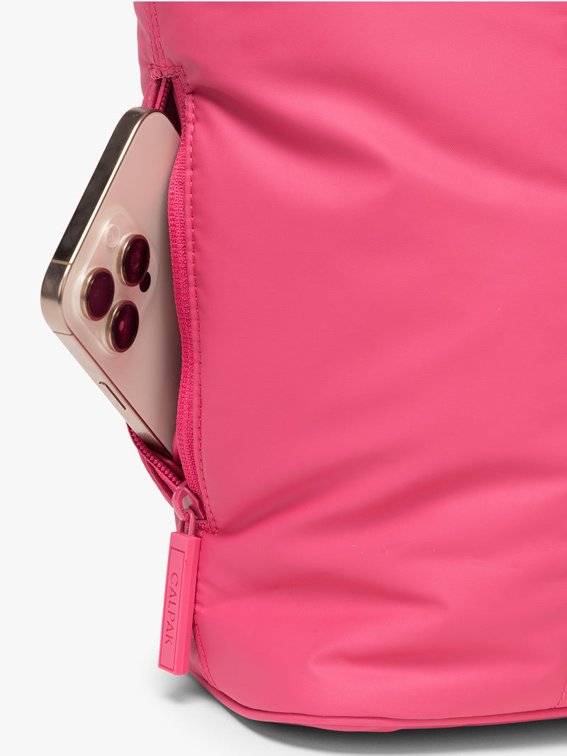 Side zippered pocket of CALPAK Luka Mini Tote in bright pink Dragonfruit on a white background