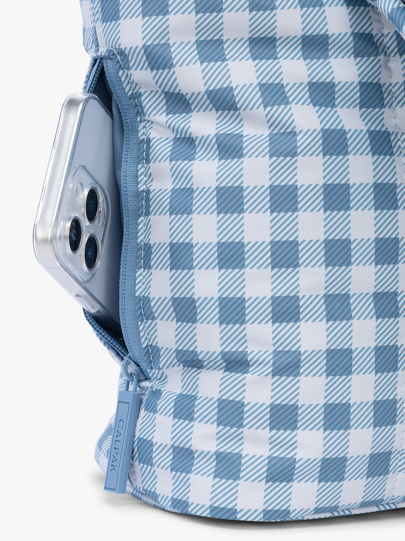 Side phone pocket with zipper of CALPAK Luka Mini Tote in white and blue gingham pattern in French Blue Gingham