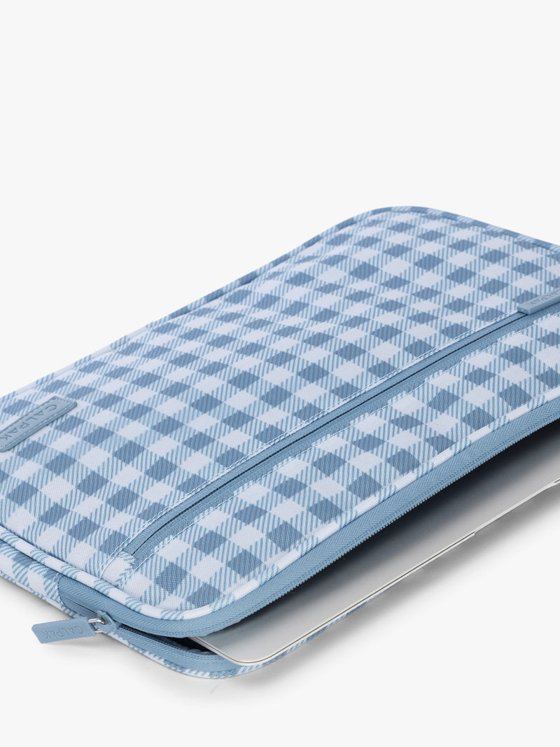 Flatlay with laptop in the CALPAK Padded Laptop Sleeve 13" in white and blue gingham print in French Blue Gingham