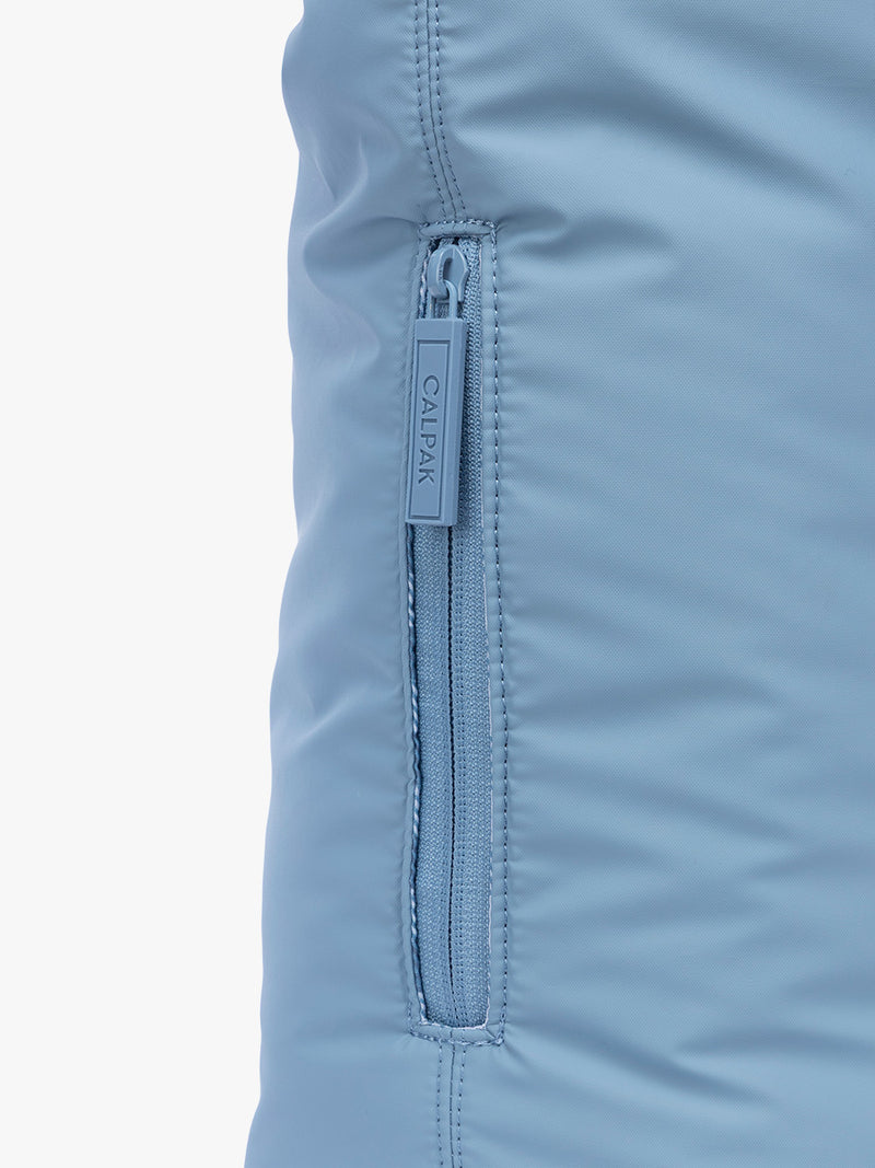 SIde phone pocket with zipper of CALPAK Luka Expandable Tote in light blue French Blue