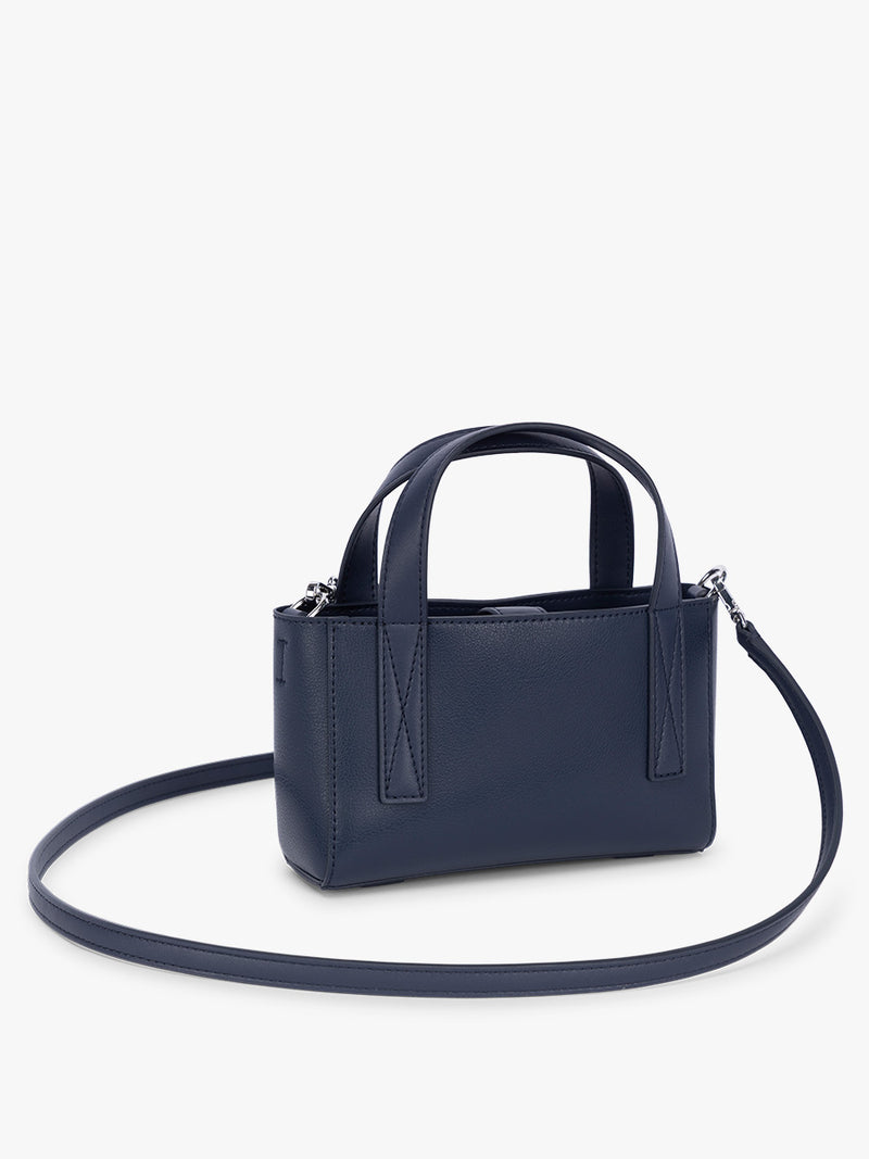 Side view of CALPAK Haven Mini Crossbody Bag in dark blue Navy