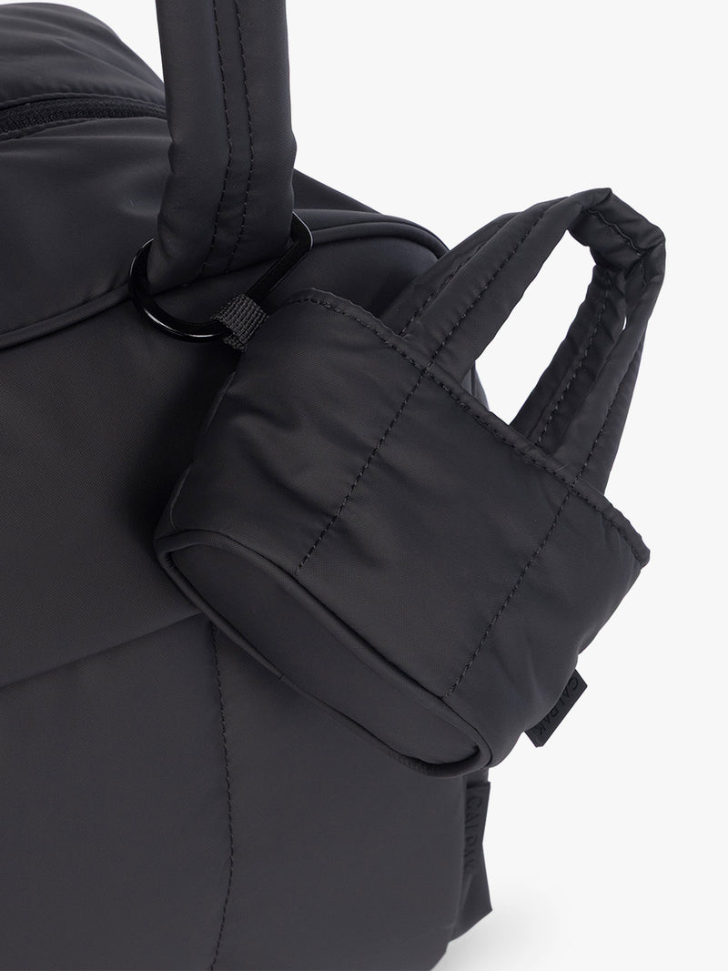 CALPAK Luka Tote Zip Bag Charm in Matte Black with carabiner attached to bag