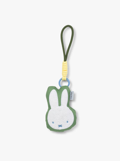 Plush Miffy x CALPAK Pluffy Bag Charm keychain with a green border and Miffy on a white background; APLF2501-GREEN-MIFFY view 1