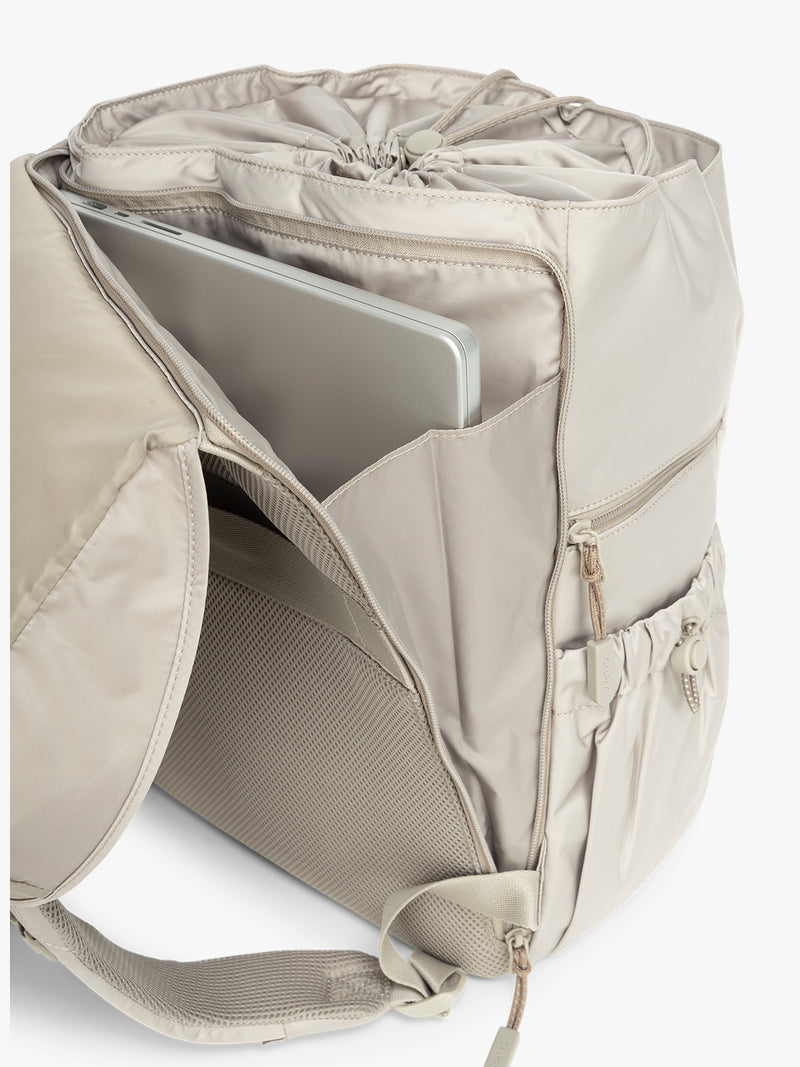 Laptop sleeve on the back of CALPAK Fit Gym Backpack in beige Greige with white background