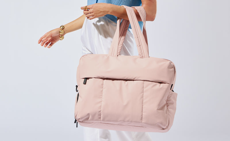 Model wearing the Large Luka Duffel in light pink Rose Quartz