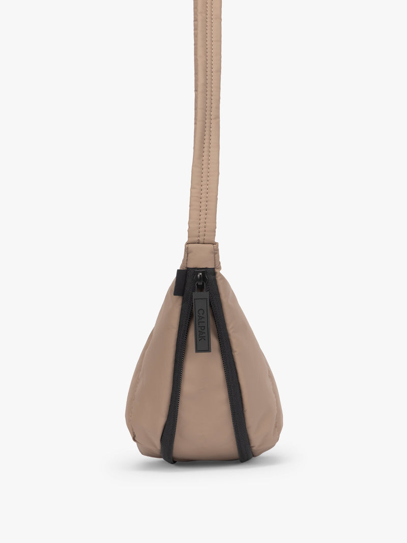 Side view showing expandable function of the CALPAK Luka Crescent Tote bag in light brown Chocolate with shoulder strap and bag is expandable up to 2"
