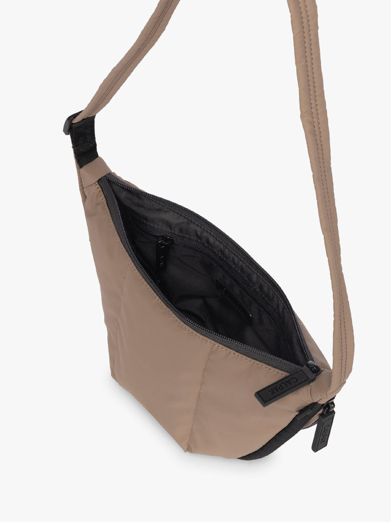 Opened interior of CALPAK Luka Crescent Tote bag in light brown Chocolate with shoulder strap and bag is expandable up to 2"