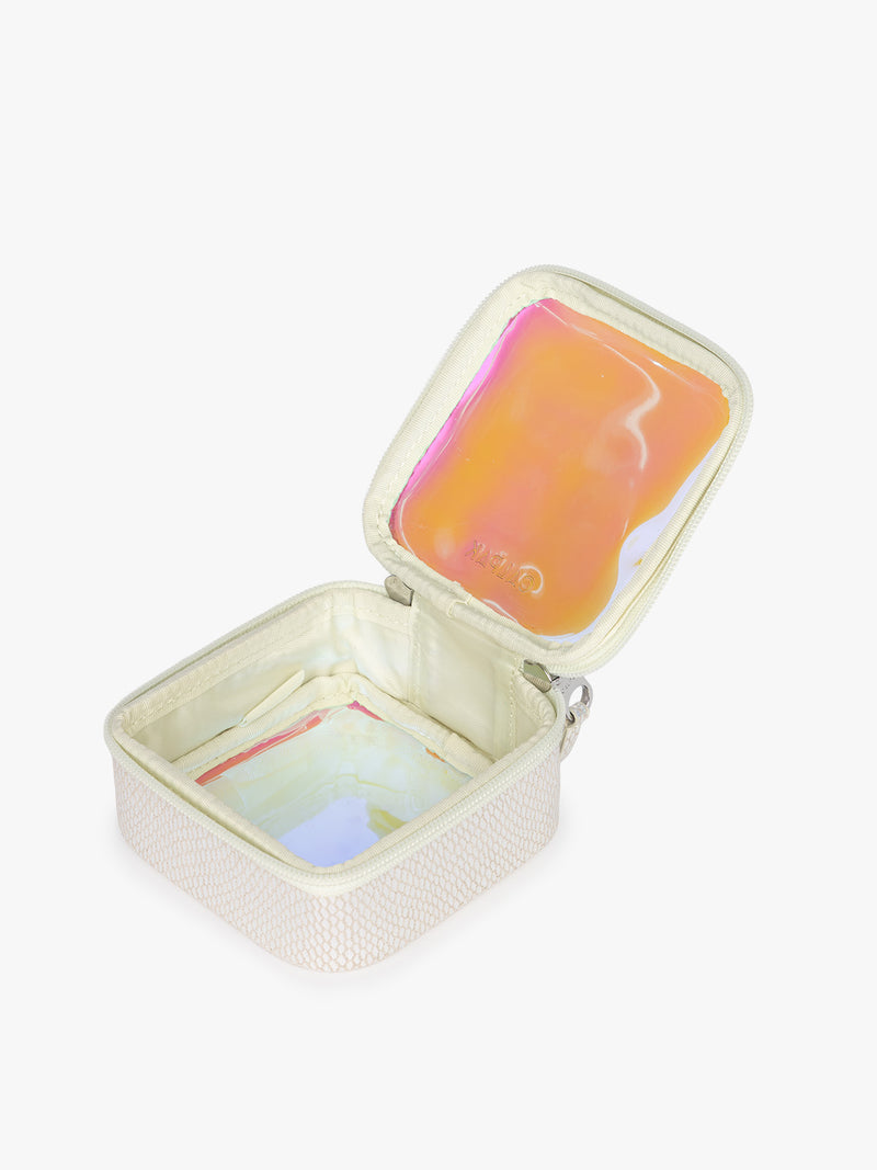 Opened CALPAK Tiny Clear Cometic Case that is square-shaped in iridescent with pink in Moonbeam with a white border on a light gray background