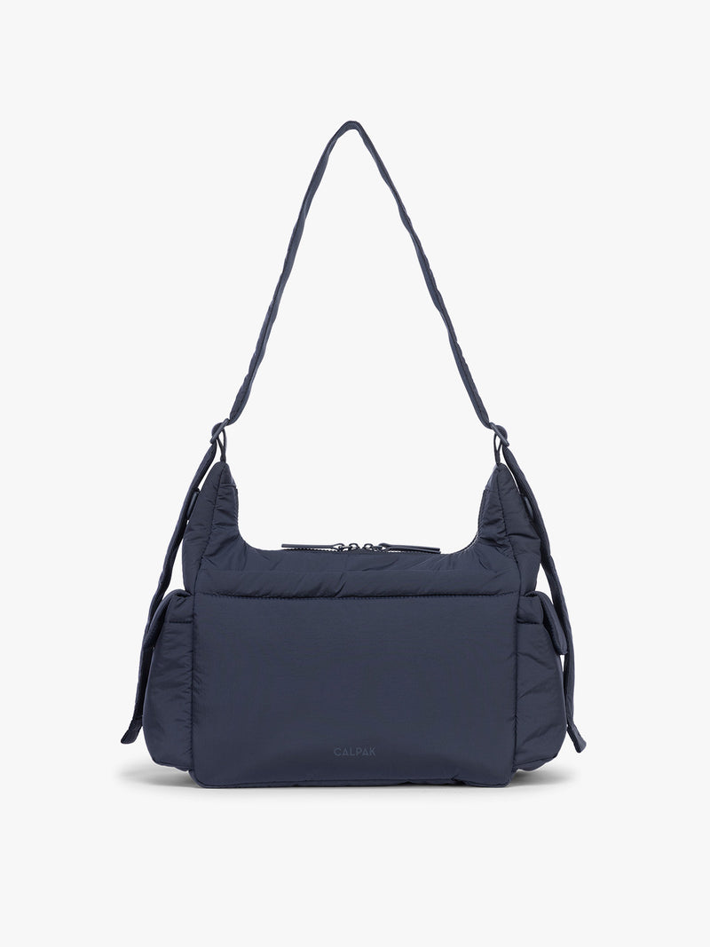 Backside of CALPAK Crossbody Diaper Bag in blue Navy