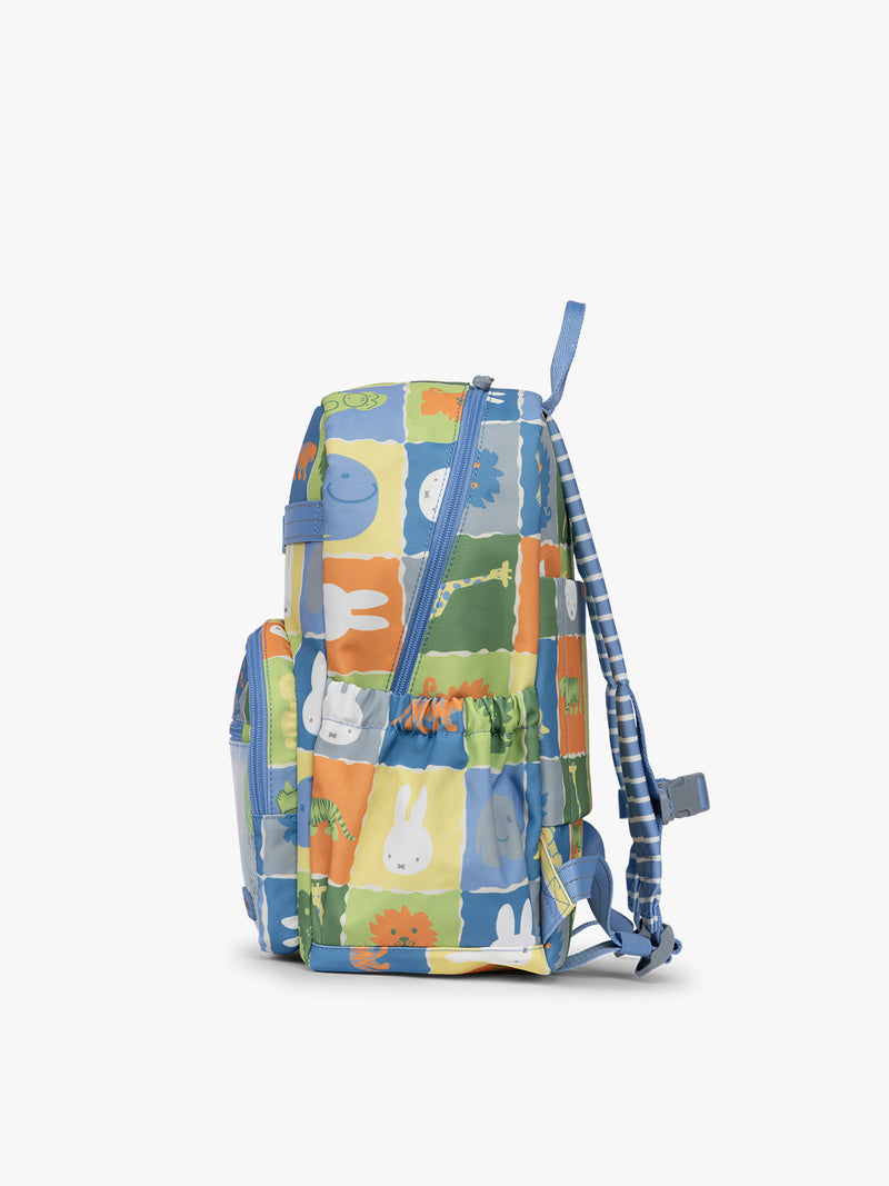 Side view of CALPAK Kids Medium Backpack with Miffy and blue colorful animal pattern on a white background
