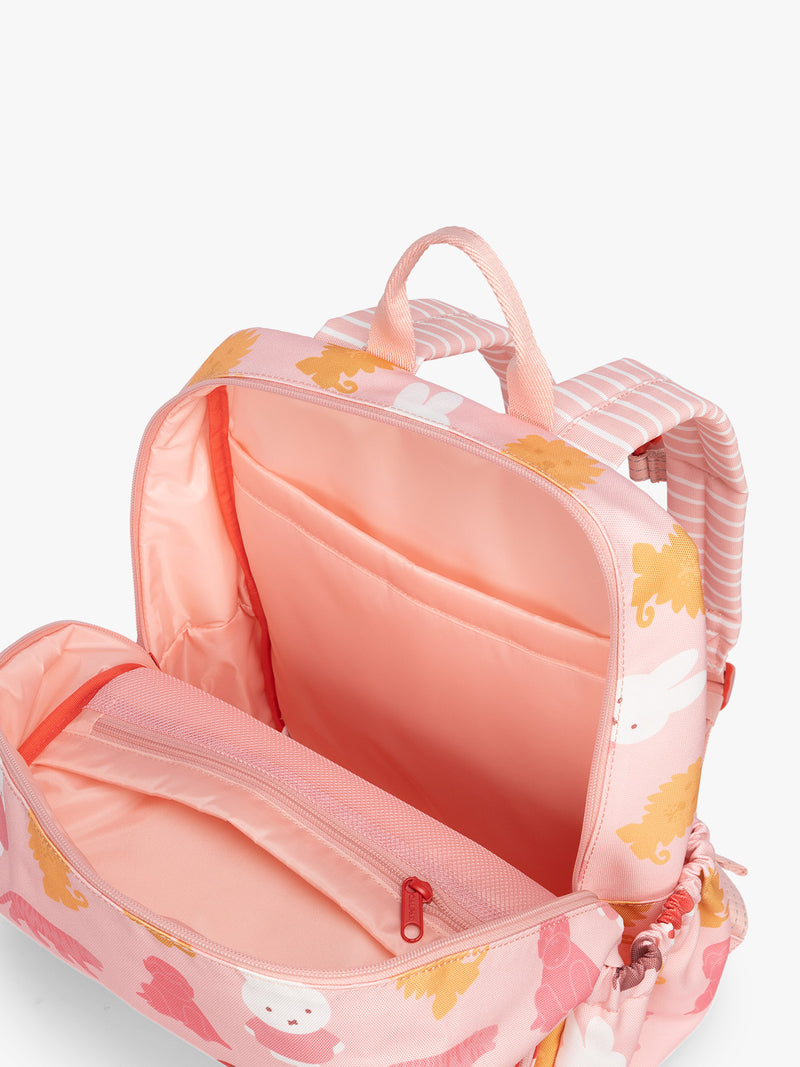 Opened pockets of CALPAK Kids Medium Backpack with Miffy and pink colorful animal pattern on a white background