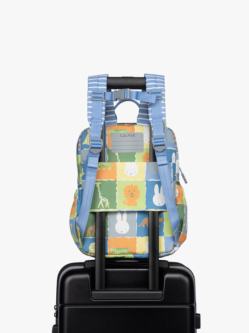 Back luggage sleeve of CALPAK Kids Small Backpack with Miffy and blue colorful animal pattern on a white background