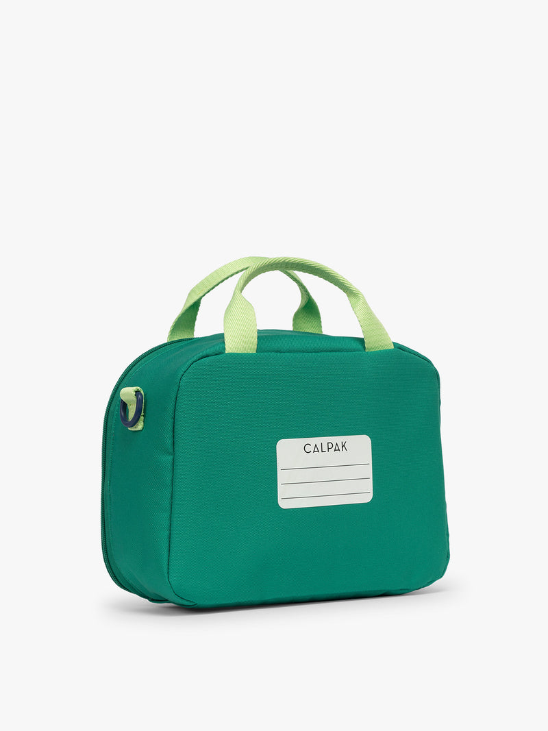 Back view with nametag of Green CALPAK Kids Lunch Bag with lime green accents and front mesh pocket on a white background