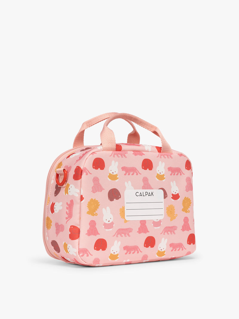 Backside with name label of the Pink CALPAK Kids Lunch Bag with Miffy and animal pattern with mesh front pocket and top handles on a white background