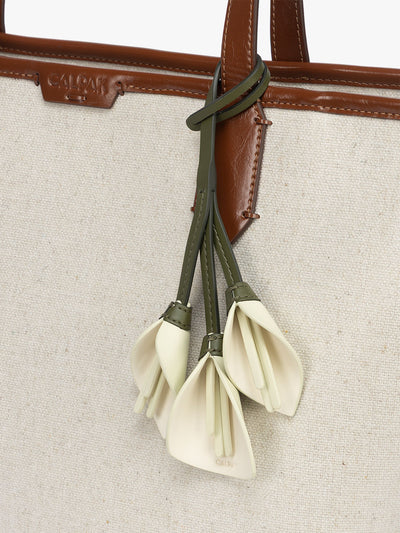 CALPAK Colette Calla Lilly Bag Charm with dark green strap and Celadon flower stem and white petals; CLBC2601-CELADON view 2