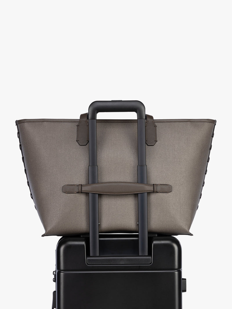 Trolley sleeve of CALPAK Colette 15" Canvas Laptop Tote in brown canvas material