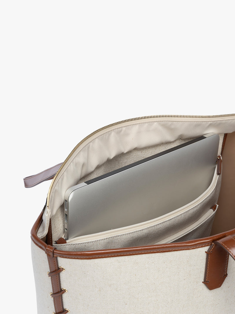 Laptop sleeve of CALPAK Colette 15" Canvas Laptop Tote with zipper and laptop sleeve in beige canvas material with brown finishing in Natural Brown