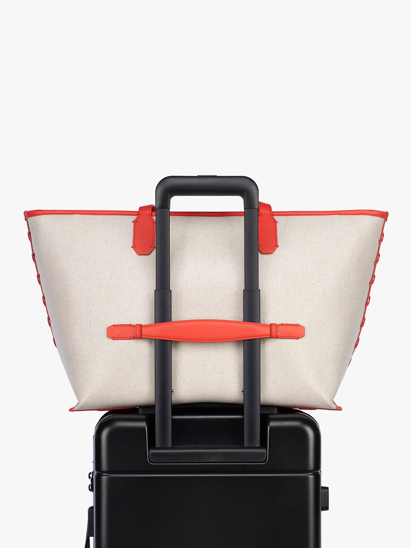 Trolley sleeve of CALPAK Colette 15" Canvas Laptop Tote in beige canvas material  with red finishing in Natural Tomato