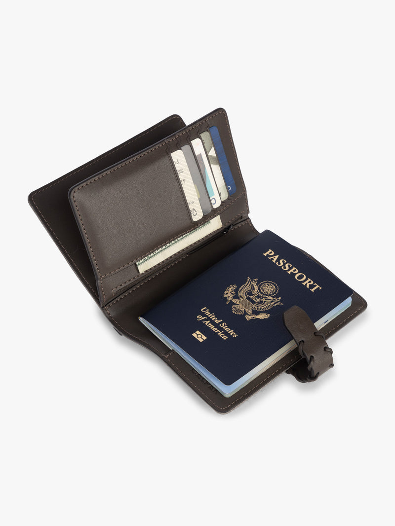 Opened with passport and card slots of CALPAK Colette Multi Passport Wallet in brown Mushroom canvas material