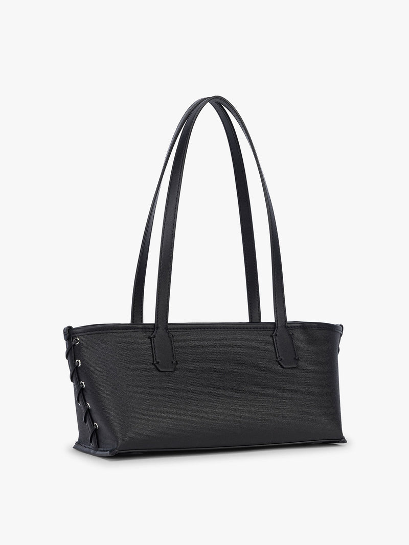 Side view and stitching of CALPAK Colette Canvas Shoulder Tote in Black canvas material with hand-finished side stich