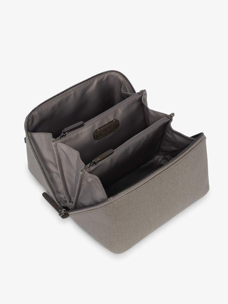 Opened CALPAK Colette Lay-Flat Canvas Toiletry Bag in brown Mushroom canvas material laying flat open