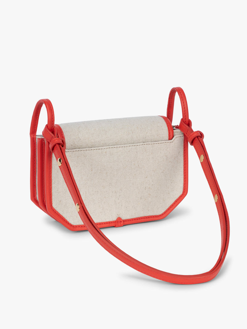 Backside of CALPAK Colette Canvas Crossbody Wallet Bag in Natural Brown with beige canvas material and red finishing