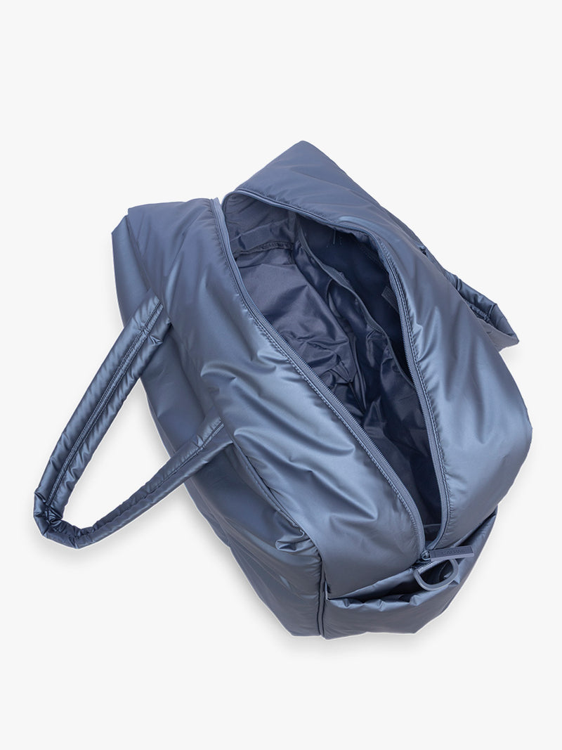 Opened interior view of CALPAK Luka Large Duffel in dark blue metallic material in Metallic Indigo