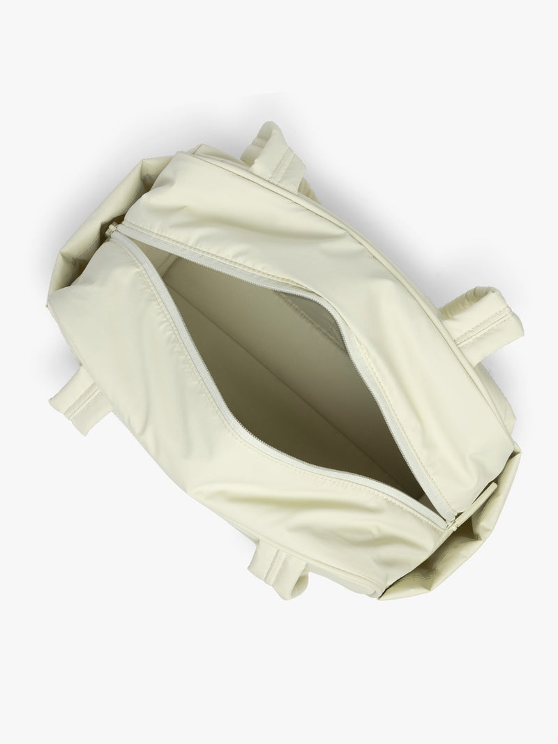 Opened CALPAK Luka Mini Duffel in light green Celadon