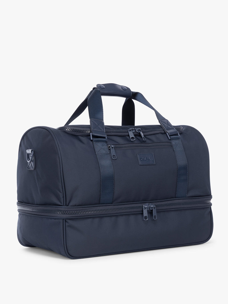 Side View of CALPAK Stevyn Duffel with Shoe Compartment in dark blue Navy