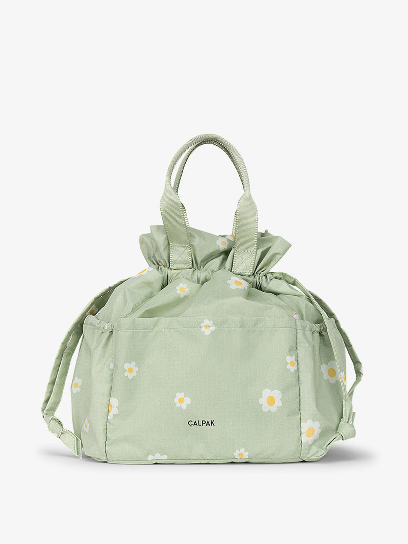 The Insulated Lunch Bag in a daisy pattern, featuring a zippered closure and a top handle. The lunch bag is designed to keep food and drinks cool