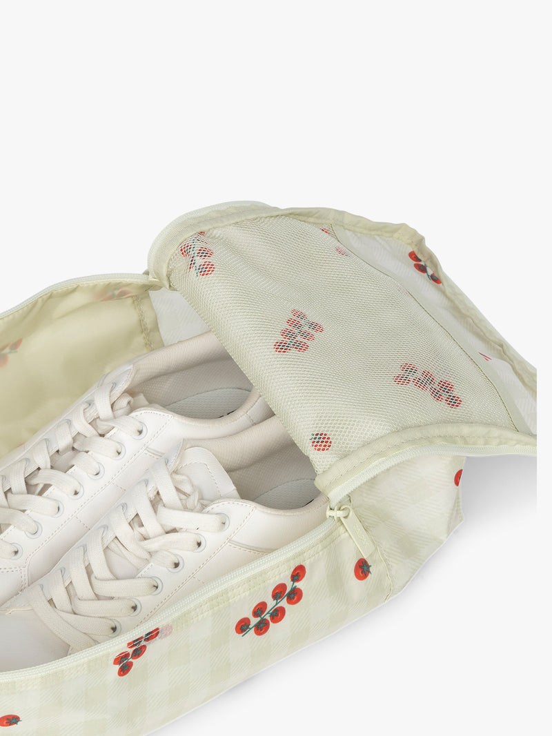 Close up CALPAK Shoe Bag in white and green gingham pattern with tomato print