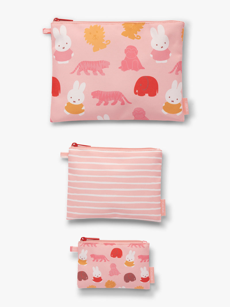 Flat-lay of set of blue, pink and white colorful children's pouches with Miffy and animal patterns for the CALPAK Compakt Zip Pouch Set on a white background