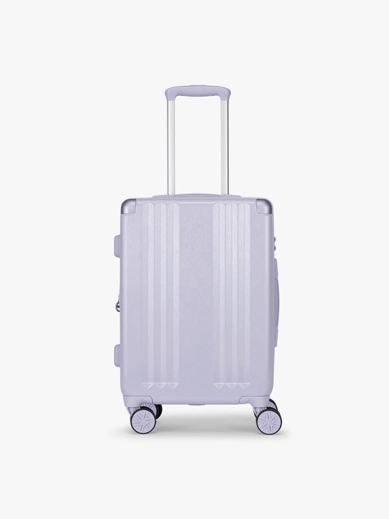 CALPAK Two Piece Amber Luggage Set with Carry On size in light purple lavender with handles and spinner wheels on a white background