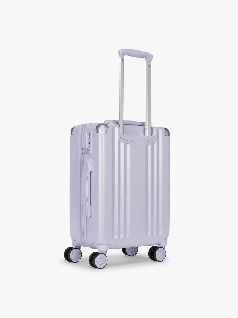 Back view of the CALPAK Ambeur Carry On Luggage in light lavender in Sea Glass with handle and spinner wheels on a white background