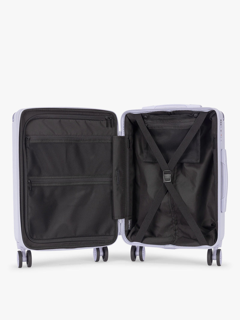 Opened CALPAK Ambeur Carry On Luggage in light lavender in Sea Glass with handle and spinner wheels on a white background