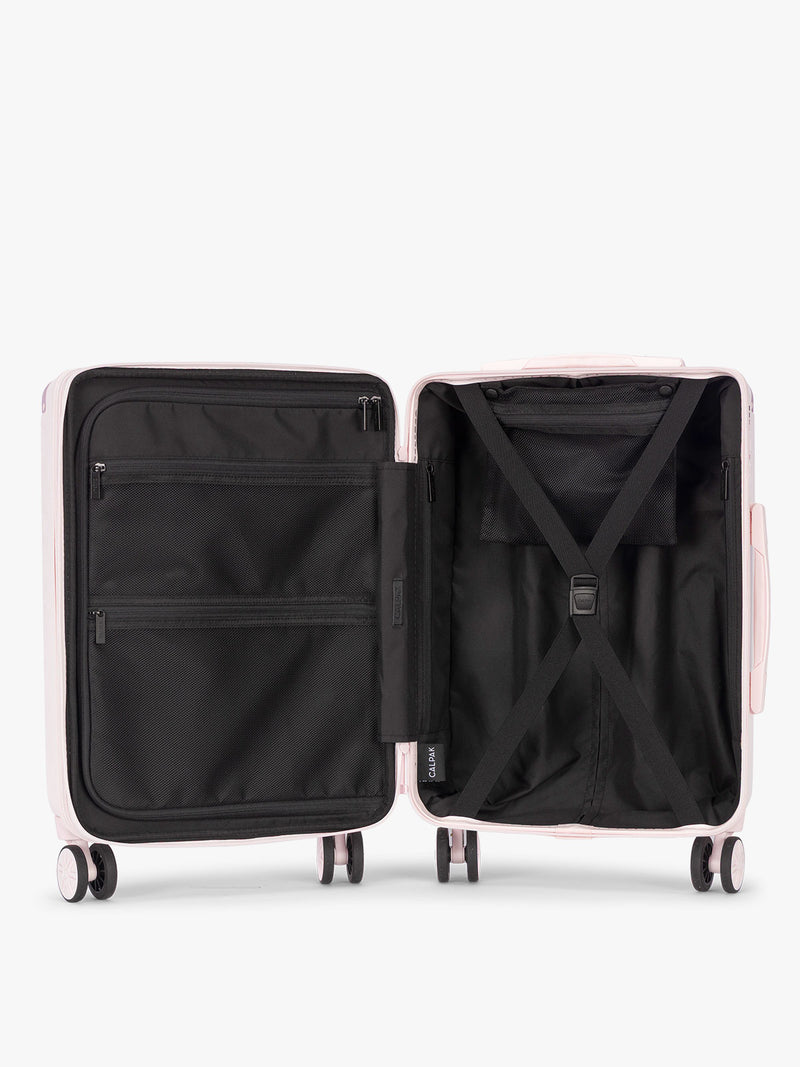 Opened CALPAK Ambeur Carry On Luggage in light pink Shell Pink with handles and wheels