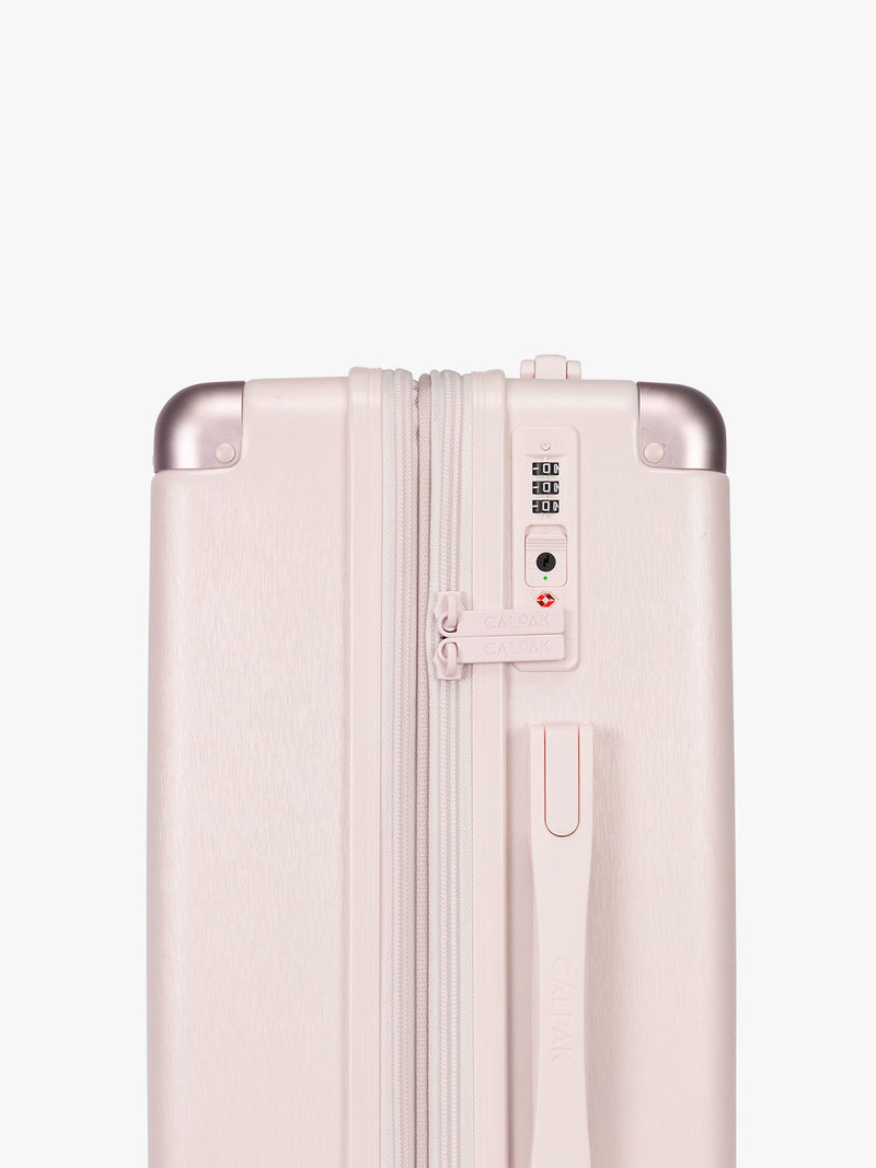 Side TSA approved lock of CALPAK Ambeur Medium Luggage in light pink Shell Pink with handles and wheels
