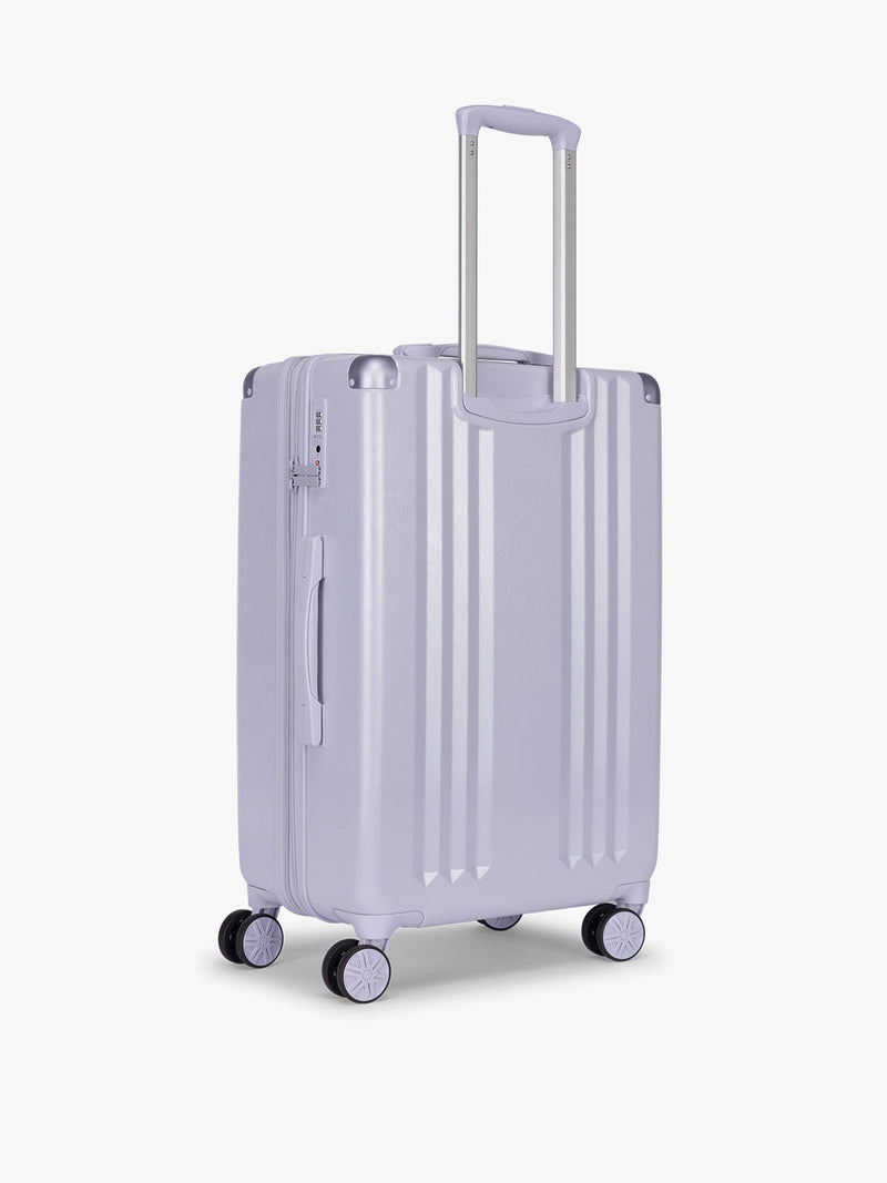 Back side of CALPAK Ambeur Medium Luggage in light lavender purple in Sea Glass with handles and spinner wheels on a white background