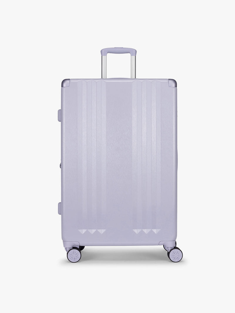 CALPAK Ambeur three piece luggage set in large size in light purple lavender with handles and spinner wheels on a white background